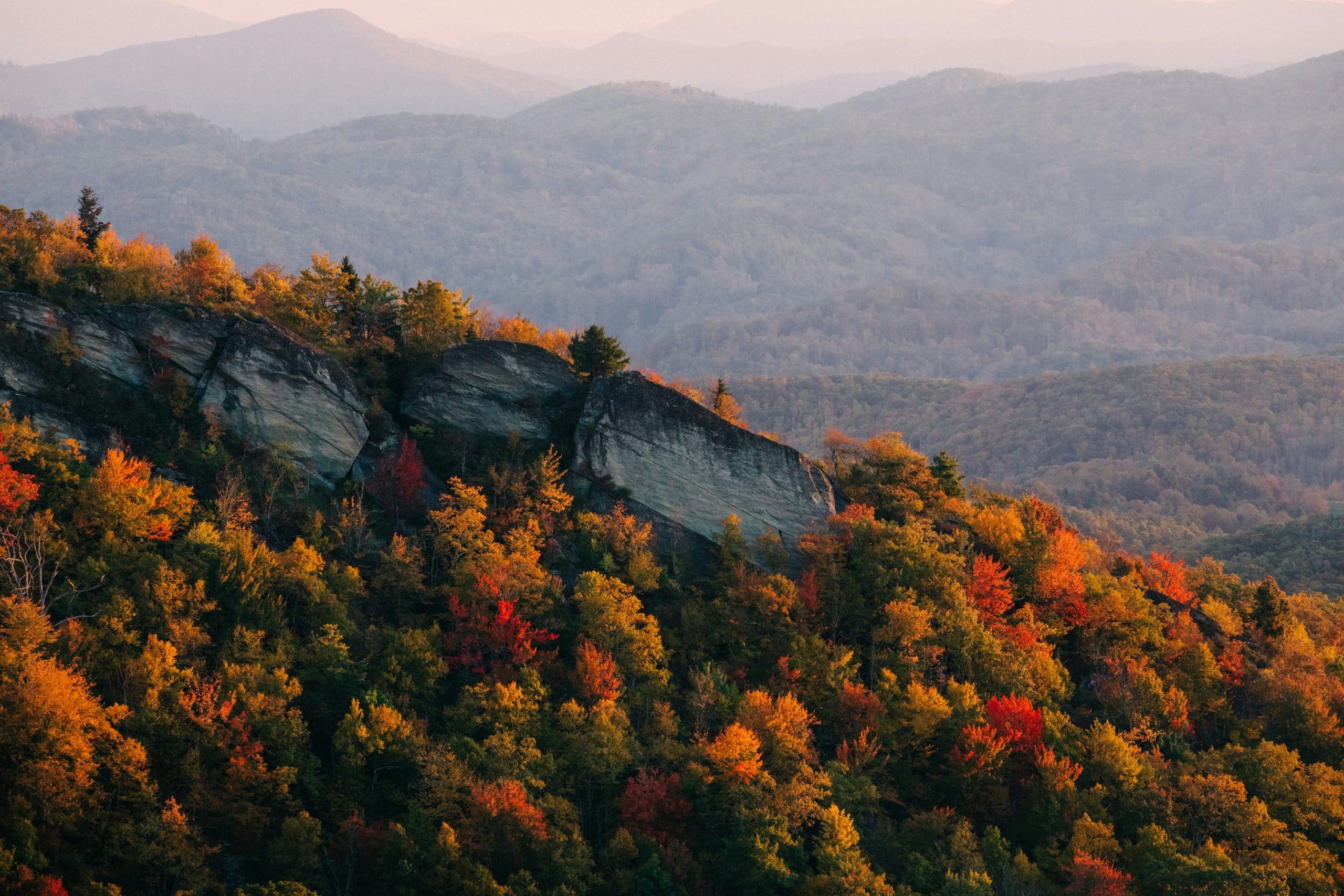 Wide view of the Blue Ridge Mountains covered in vibrant fall foliage, evoking the stability, legacy, and peace of mind that Estate Planning of the Carolinas provides to families planning for the future.