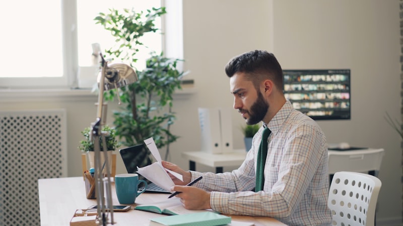 Man reading estate plan document in office setting